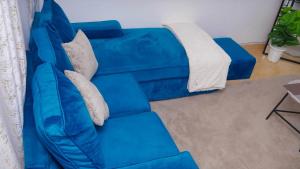 a blue couch sitting in a living room at SJ Homes II in Eldoret