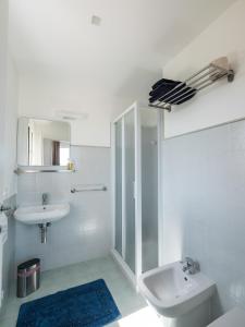 a white bathroom with a sink and a toilet at Agriturismo Le Crede 1930 in Portogruaro +26 photos