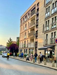 a group of people walking down a street next to a building at No̱410 City View Apartment & free parking in Krakow