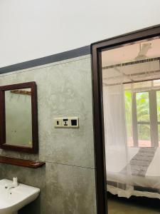 a bathroom with a sink and a mirror at Sky Mountain Café with seaview in Weligama +106 photos