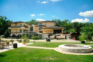 a large building with a fountain in a yard at Curtea Domneasca in Vaslui