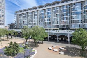 a large building with trees in front of it at Fox Hotel The Hague Scheveningen in Scheveningen