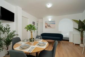 a living room with a wooden table and chairs at ILIOS COVE by A&D Properties in Porto Rafti