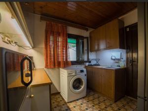 a small kitchen with a washing machine in it at Beutiful view Cosy House with Starlink internet in Salamina +5 photos