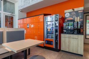 a soda machine next to a table in a store at Fox Hotel The Hague Scheveningen in Scheveningen
