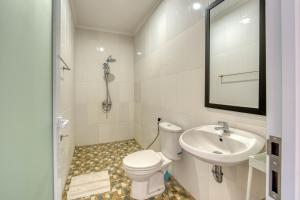 a white bathroom with a toilet and a sink at narayuka house in Seminyak +35 photos