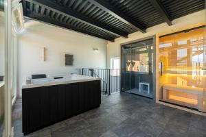 a kitchen with a counter and a glass door at Corte Tegassa Pool & Spa in Pinerolo