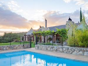 an estate with a swimming pool and a house at Swartklip Game Lodge in Riversdale