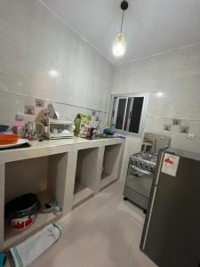 a kitchen with a counter and a stove in it at Appartement confort keur massar in Rufisque