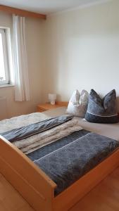 a bed with pillows on it in a bedroom at Ferienwohnung Kathrin in Mariahof