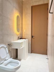 a bathroom with a toilet and a sink at Zabibu Residence in Nkongontha