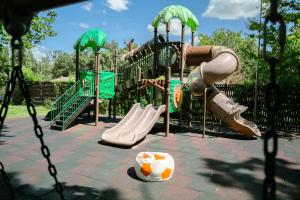a park with a playground with slides and a slideintend at Curtea Domneasca in Vaslui