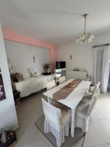 a dining room with a white table and chairs at For a good hospitality in Souvala