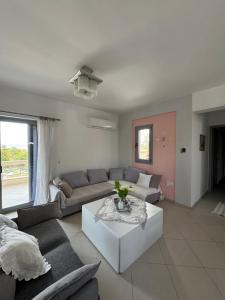 a living room with a couch and a table at For a good hospitality in Souvala