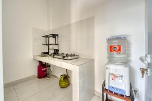 a kitchen with a sink and a counter with a water tank at narayuka house in Seminyak