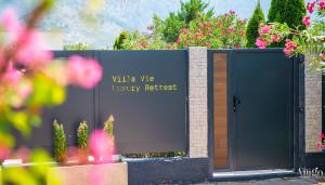 a black gate with a sign that reads villa ville luxury retreat at Villa Vie Luxury Retreat in Blagaj