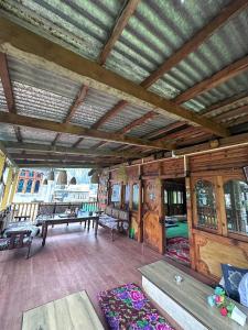 a living room with wooden walls and a wooden ceiling at Boom Shankar in Kalgha