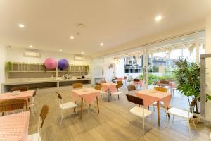 a restaurant with tables and chairs in a room at Arsh Boutique Hotel in Chiang Mai