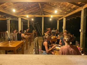 a group of people sitting at tables in a restaurant at Sky Mountain Café with seaview in Weligama