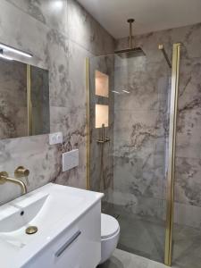 a bathroom with a toilet and a sink and a shower at Azur Pearl - Luxury Sea View Apartement - La plage à vos pieds in Nice