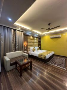 a hotel room with a bed and a couch at HOTEL ROYAL MILAD in Srinagar