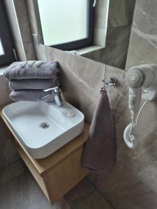 a bathroom with a sink and a towel dispenser at WILLA KORSARSKA in Władysławowo +64 photos