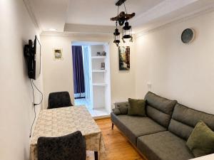 a living room with a couch and a table at Mestia Central Apartment in Mestia