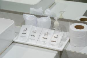 a counter with white towels and a roll of toilet paper at Arsh Boutique Hotel in Chiang Mai +93 photos