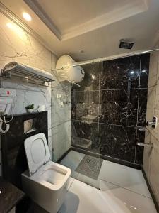 a bathroom with a sink and a toilet and a shower at HOTEL ROYAL MILAD in Srinagar