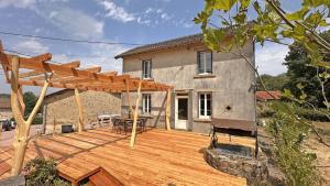 a wooden deck in front of a house at Le charron in Saint-Mathieu