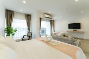 a hotel room with a bed with towels on it at Arsh Boutique Hotel in Chiang Mai