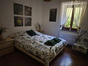 a bedroom with a bed with two pillows on it at Apartament BARBARA in Branzi