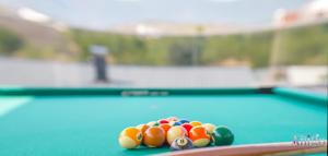 a group of balls on a pool table at Villa Vie Luxury Retreat in Blagaj