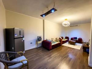 a living room with a couch and a refrigerator at RAFiF Pyramids View Hotel in Cairo