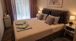 a bedroom with a bed with two pillows on it at New Moment 2 in Žarkovo