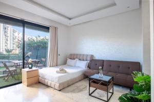 a living room with a bed and a couch at TT holidays Prestigia Hay Riad-Pool in Rabat