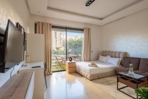 a living room with a bed and a couch at TT holidays Prestigia Hay Riad-Pool in Rabat