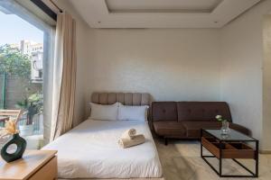 a bedroom with a bed and a couch at TT holidays Prestigia Hay Riad-Pool in Rabat +21 photos