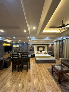 a bedroom with a bed and a couch and a table at HOTEL ROYAL MILAD in Srinagar