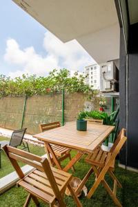a wooden table and chairs on a patio at TT holidays Prestigia Hay Riad-Pool in Rabat