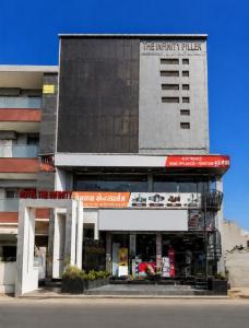a building with a store in front of it at Hotel the Infinity in Rajkot