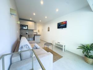 a living room with a couch and a table at Sublime apartment - Beachfront in Saint-Laurent-du-Var