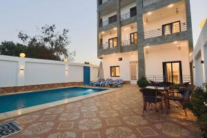 a courtyard with a swimming pool in a building at Nile Kingdom Guest house in Luxor