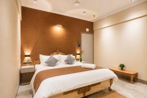 a bedroom with a large bed in a room at MG Villa - A Boutique Stay in Navi Mumbai