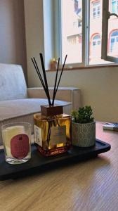 a tray with candles and plants on a table at L'instant Cosy in Gamaches