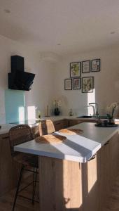 a kitchen with a island with a counter top at L'instant Cosy in Gamaches