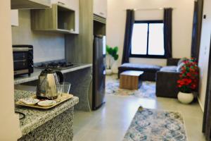 a kitchen and living room with a stove and a refrigerator at Nile Kingdom Guest house in Luxor