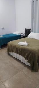 two beds in a room with two towels on a bed at Yeshua - Casa da Claudia 8 in Ilha de Guaratiba +40 photos
