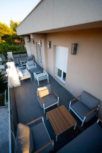 a balcony with chairs and tables on a building at Vivora Residence in Radovici