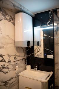 a bathroom with a white sink and a mirror at Vivora Residence in Radovici +41 photos